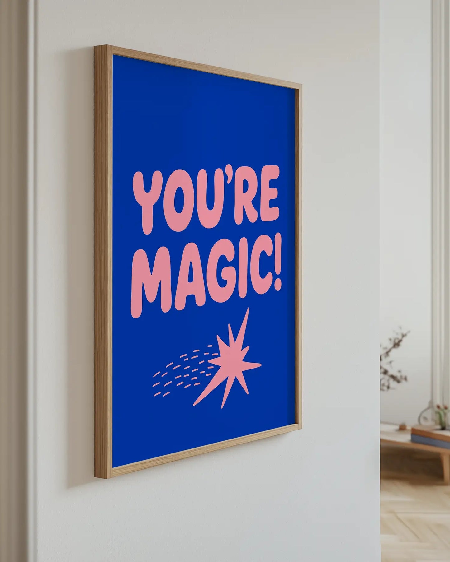 Artwork with 'YOU'RE MAGIC!' text on a blue background in a room setting.