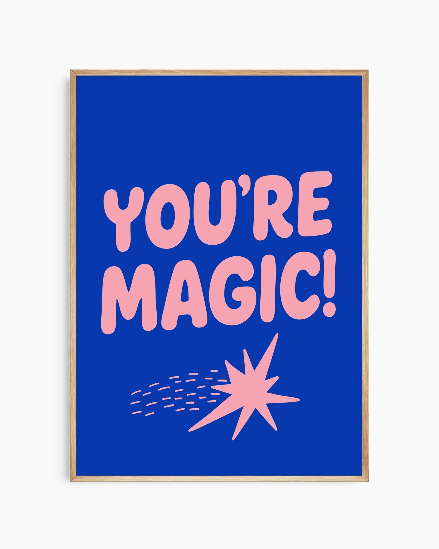 Blue nursery poster with pink text 'YOU'RE MAGIC!' and a shooting star framed in an oak frame.