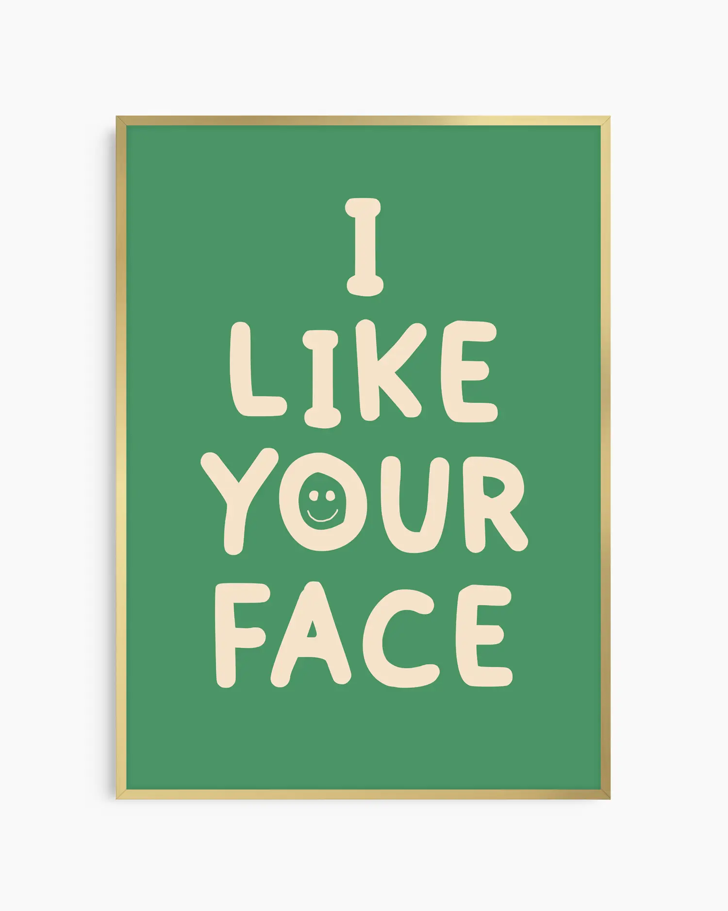 Green nursery poster with the text 'I like your face' written in beige, framed in a gold frame.
