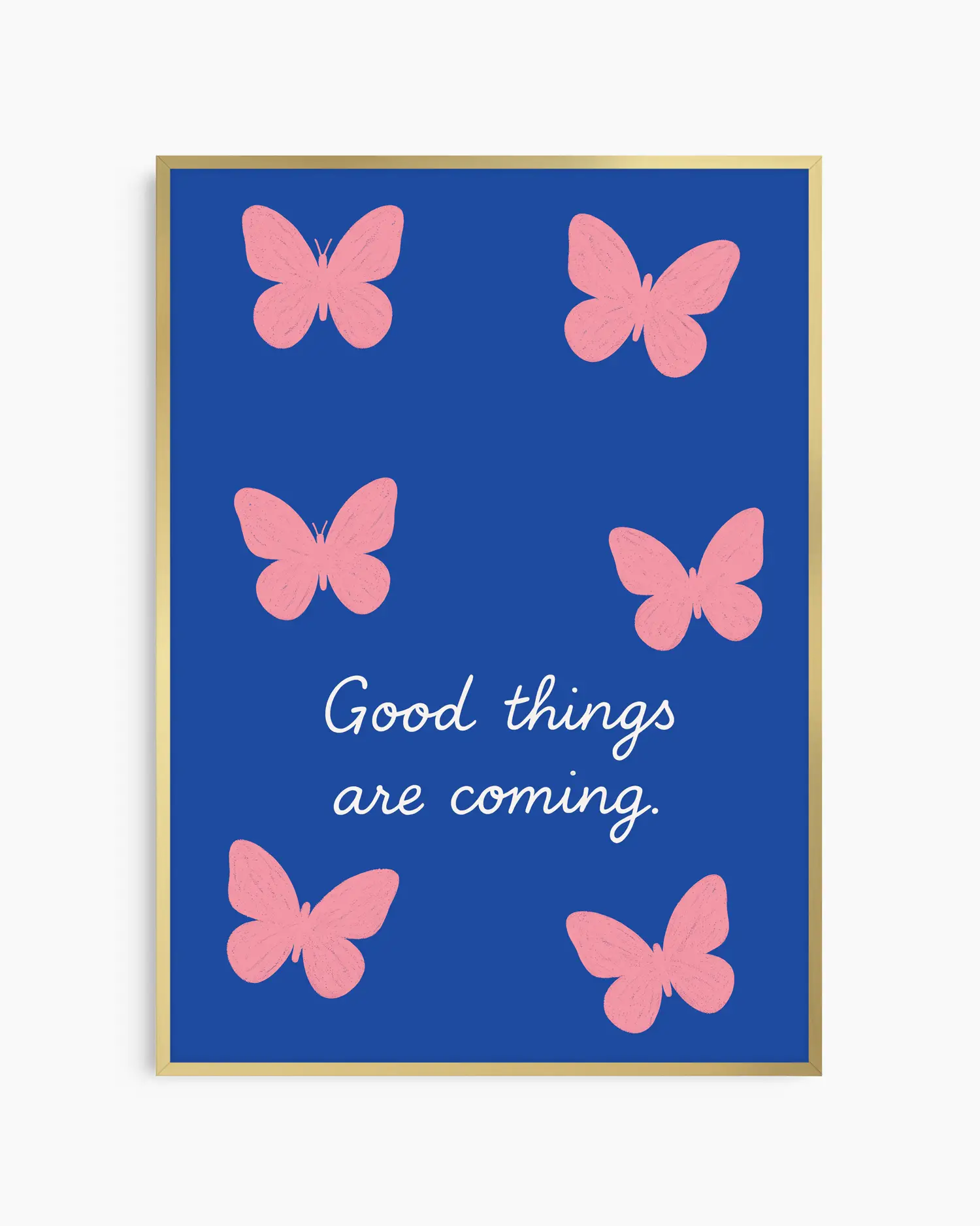 Framed artwork with pink butterflies and 'Good things are coming' text on a blue background