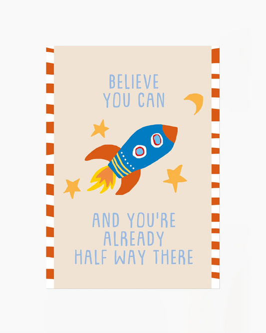 Notebook with a rocket illustration and motivational quote on a beige background