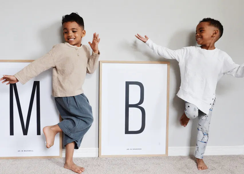 Boys with their personalized letter posters from The Birth Poster
