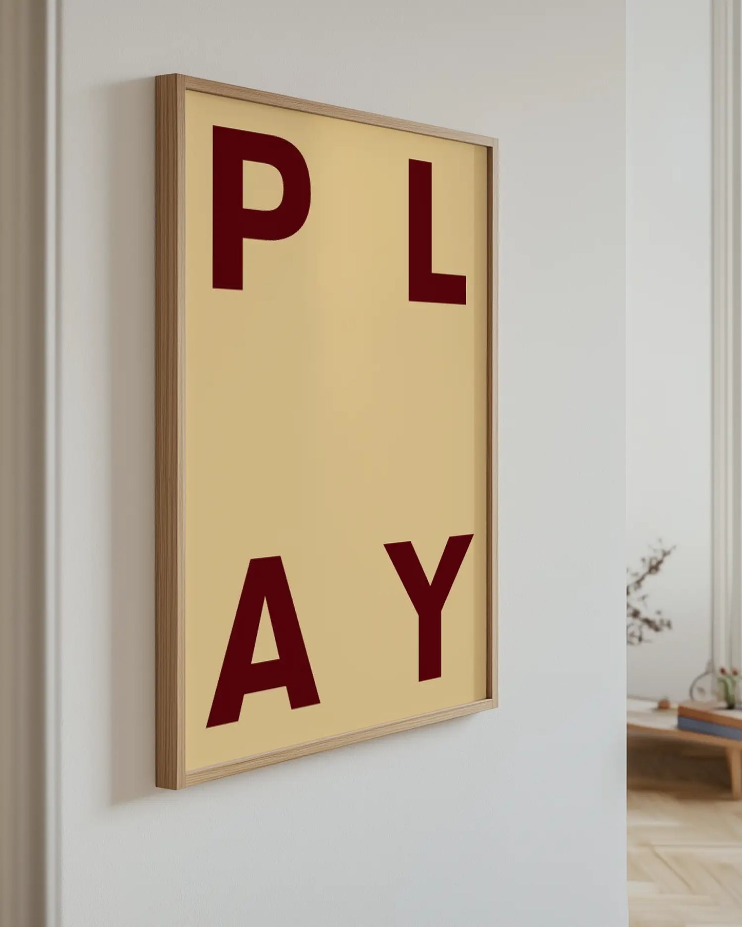 Framed artwork with the word 'PLAY' on a beige background