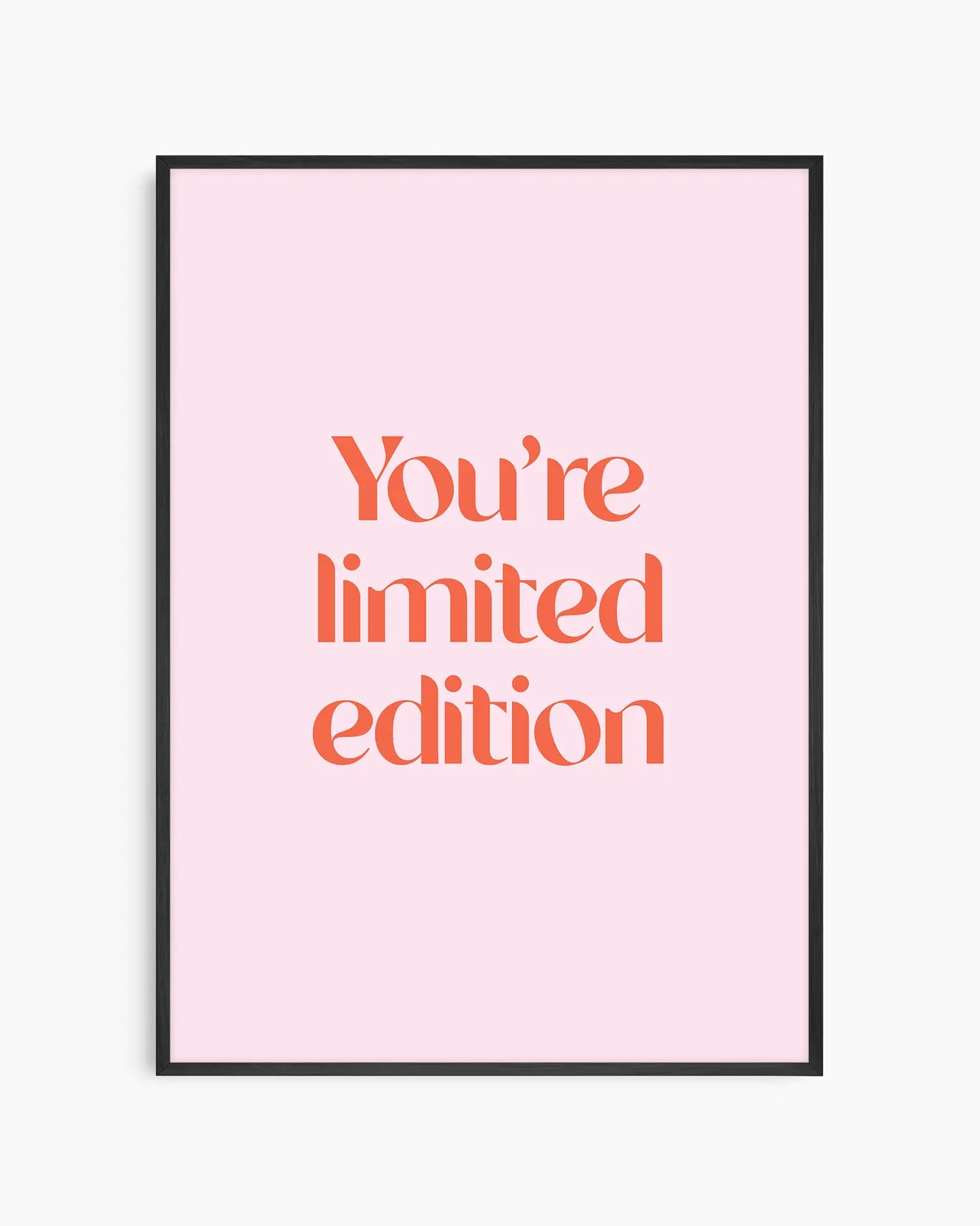 Children's poster with red text 'You're limited edition' on a pink background framed in a black frame.