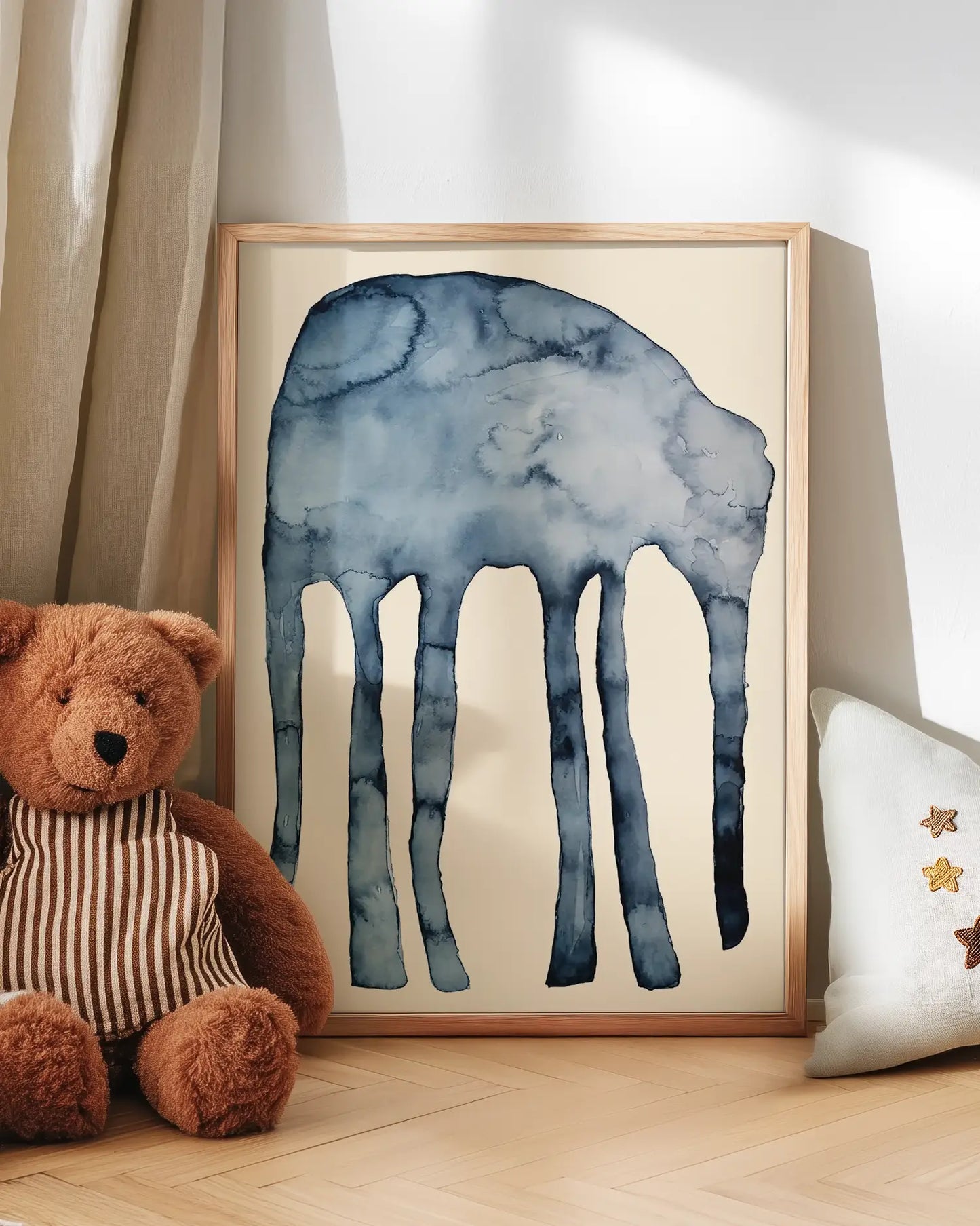 Artwork of an elephant on a wall with a teddy bear and decorative pillow.