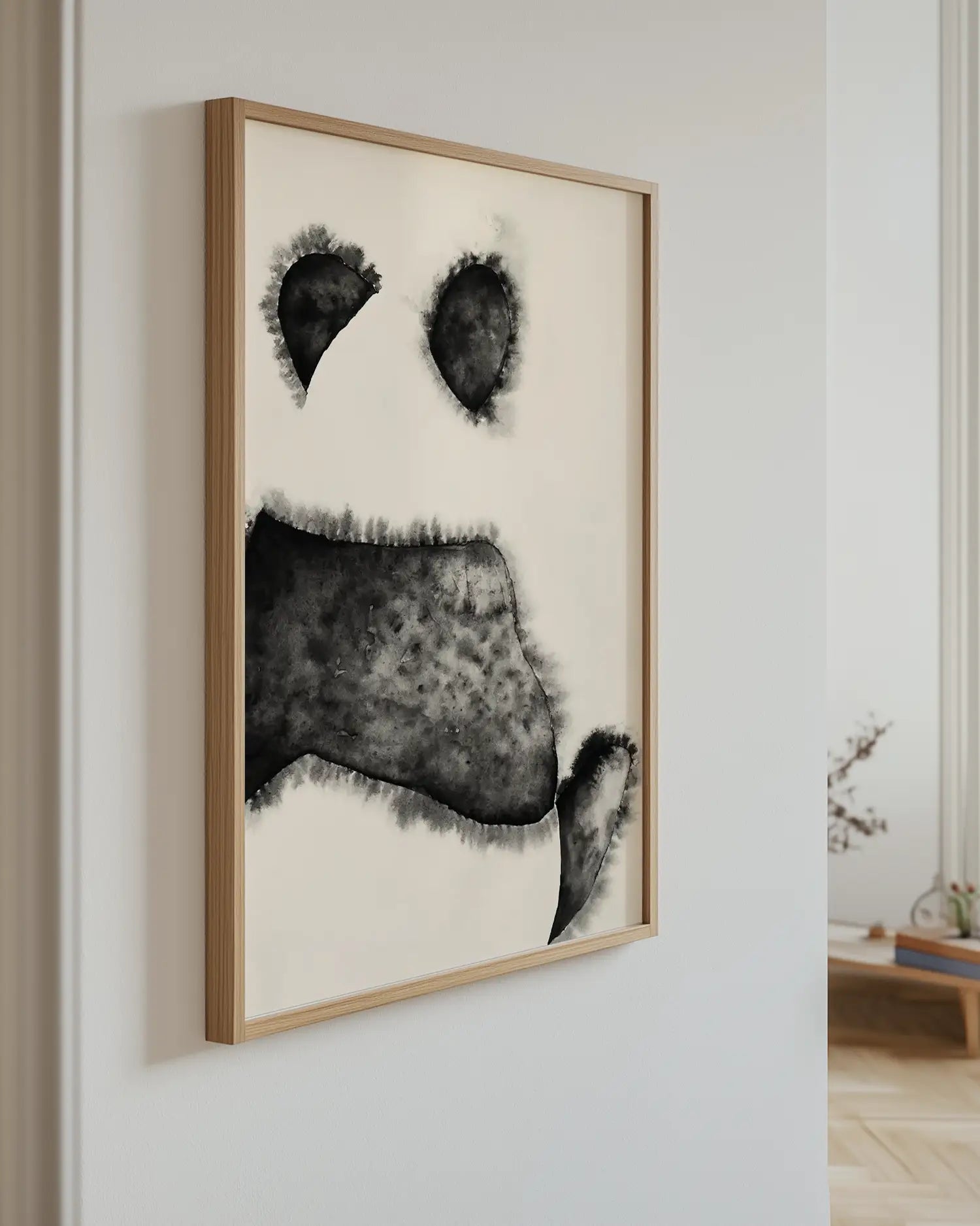 Framed artwork of a panda on a wall