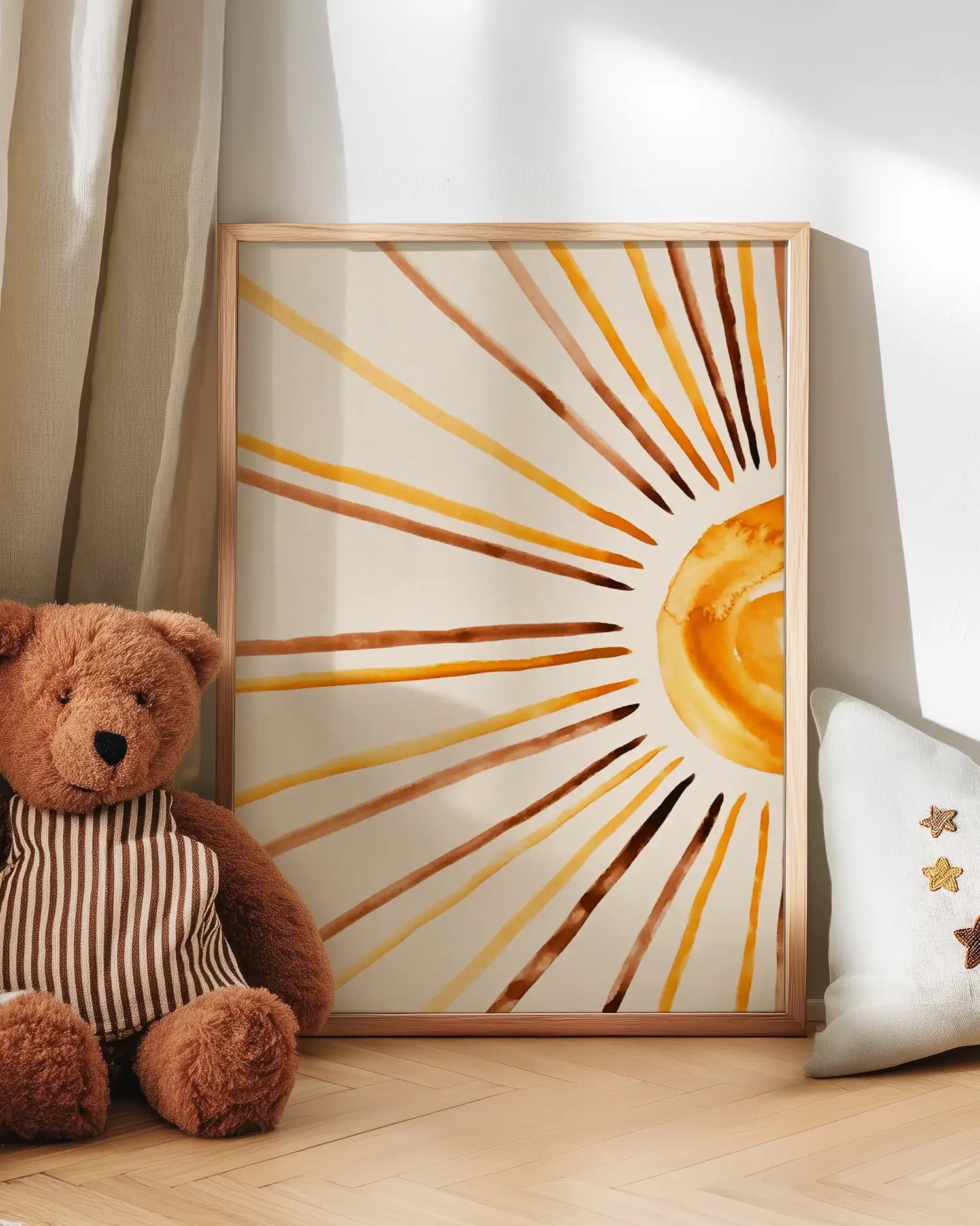 Teddy bear next to a framed artwork of a sun.