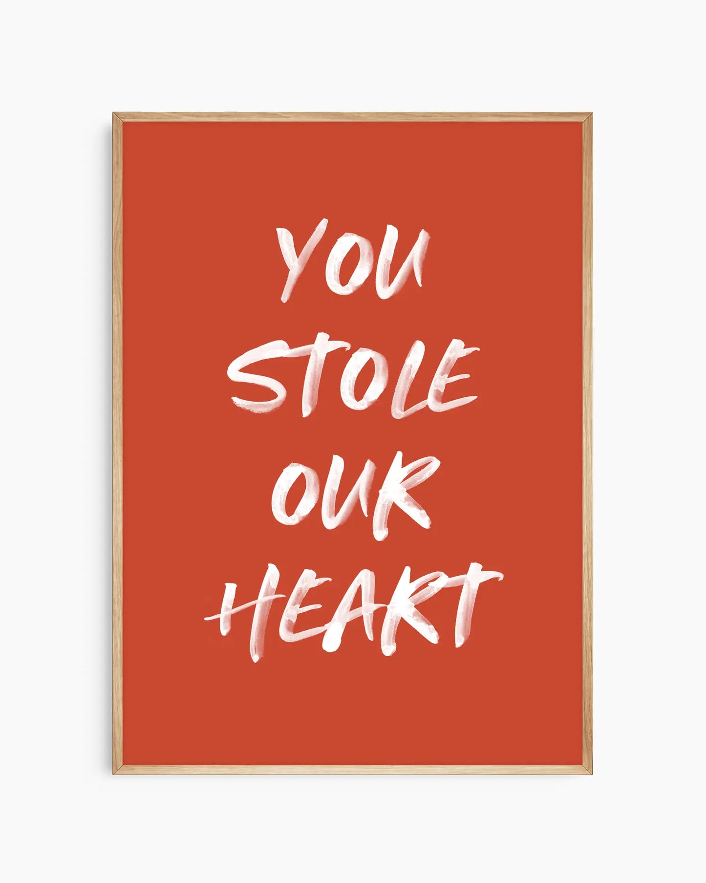 Nursery poster with white text 'You stole our heart' on a red background. Oak frame.