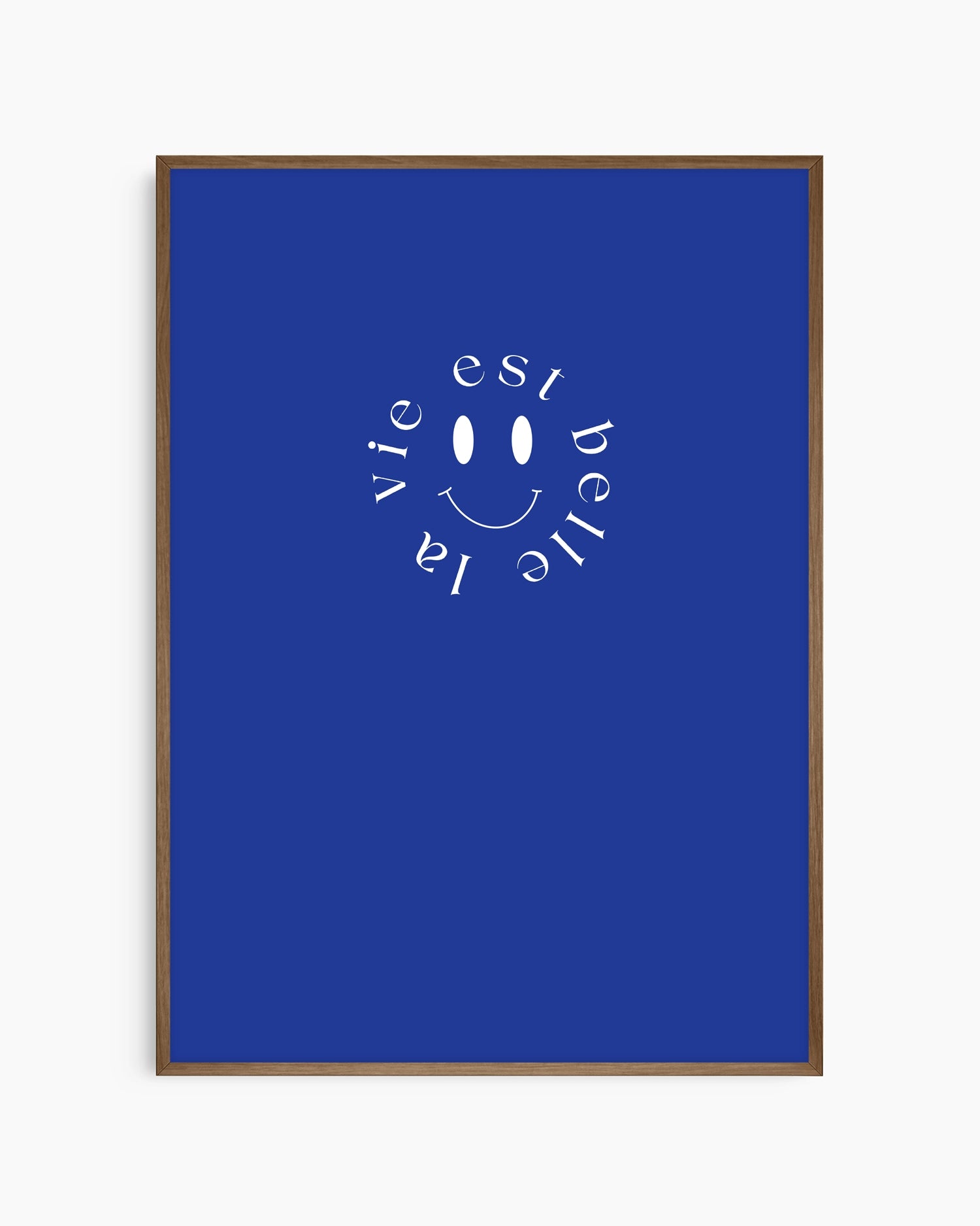 Framed poster with 'La vie est belle' text and smiley face on a blue background