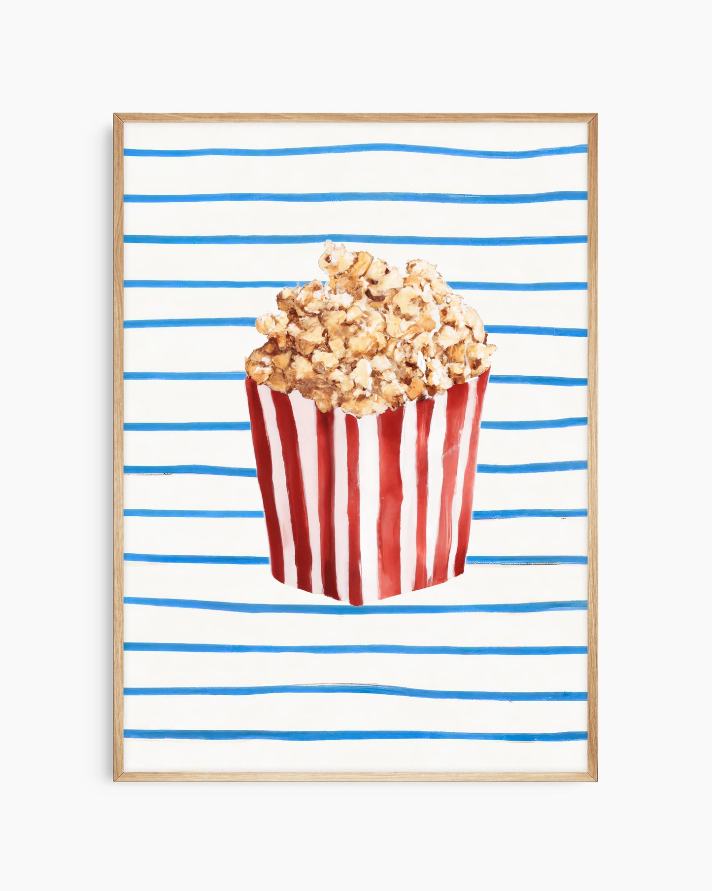 Popcorn in a red and white striped bucket on a blue and white striped background