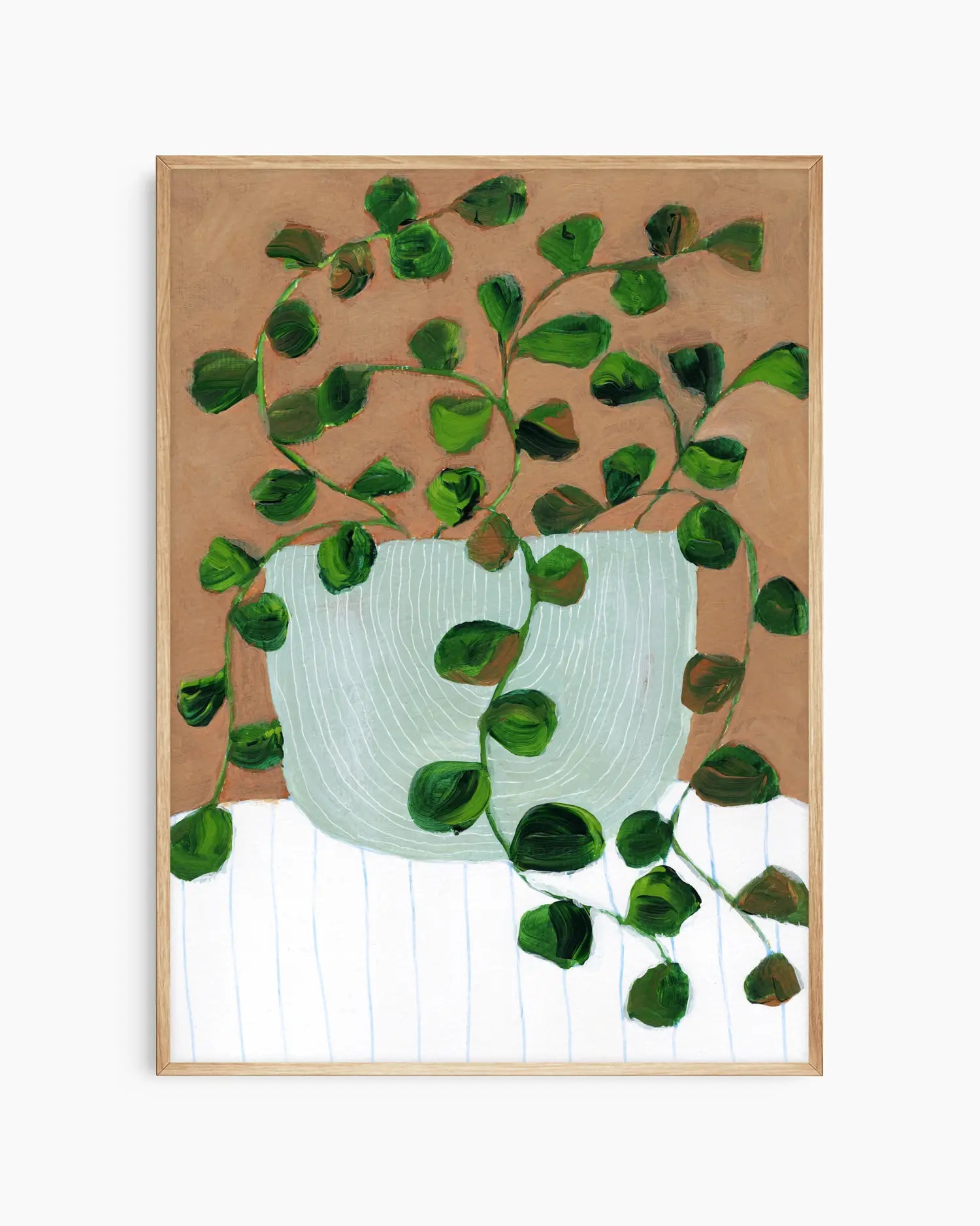 Framed artwork of a green leafy plant with a white pot on a brown background