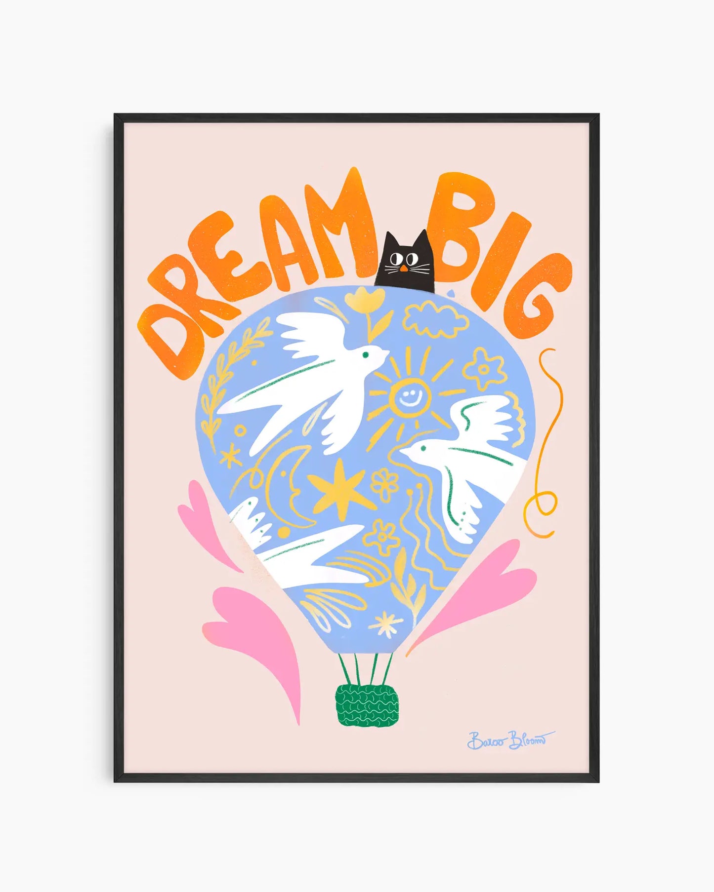 Nursery artwork with a colorful illustration of a hot air balloon, birds, and text "Dream big" on a light pink background. Framed in a black wooden frame.