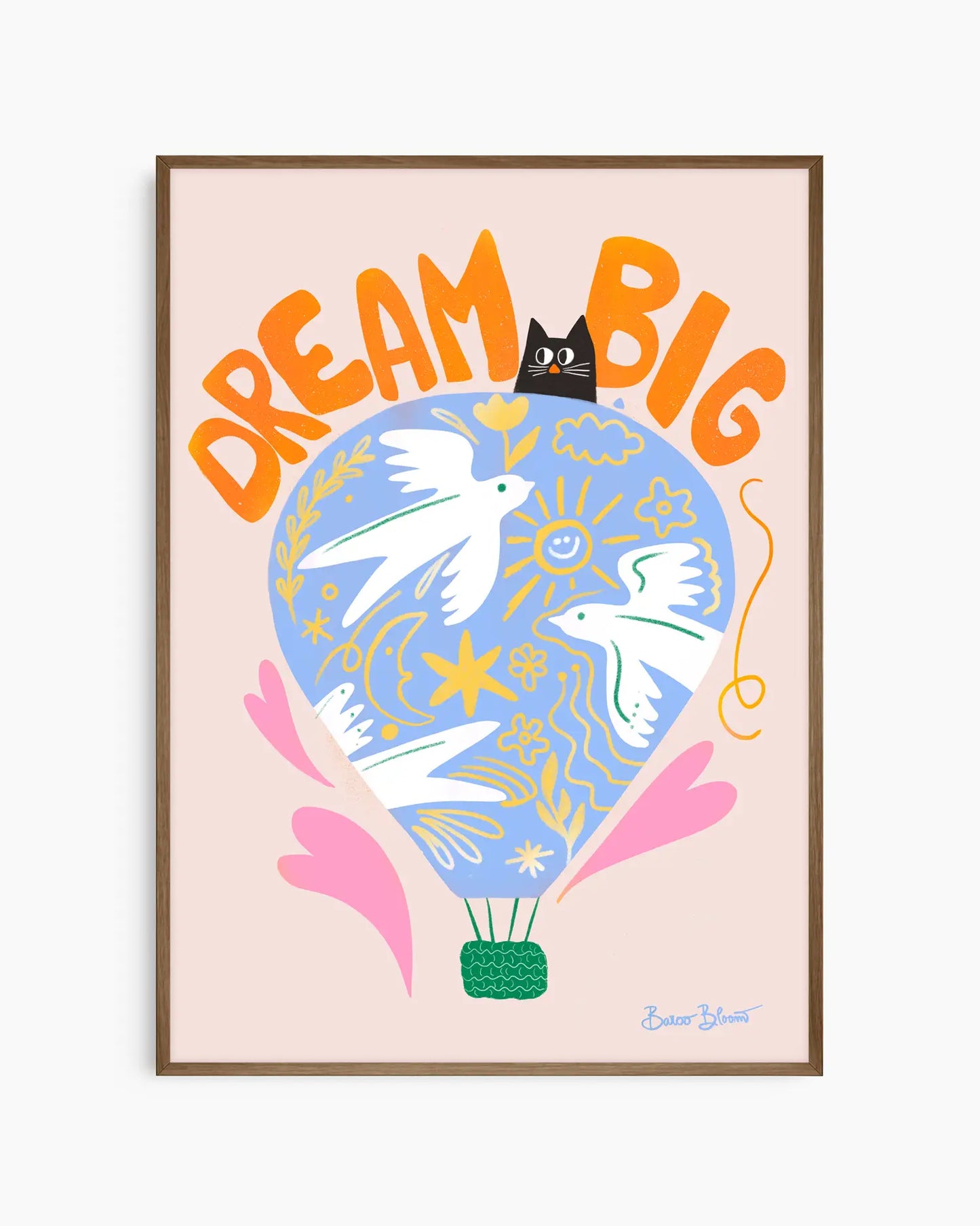 Nursery artwork with a colorful illustration of a hot air balloon, birds, and text "Dream big" on a light pink background. Framed in a smoked oak wooden frame.