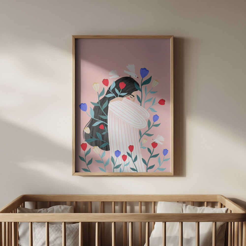 Soft pink floral poster showing a serene woman surrounded by colorful blossoms, framed in light wood and hanging above a baby’s crib. Perfect nursery wall art with a calm, loving, and artistic aesthetic.
